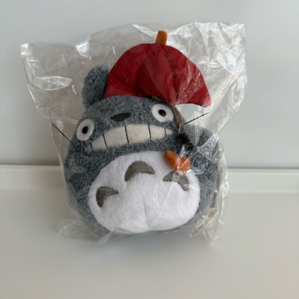 Gray and White Stuffed Animal with Red Umbrella